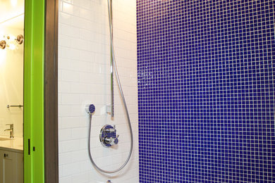 Tub/shower combo - farmhouse kids' blue tile ceramic tile tub/shower combo idea in Calgary with recessed-panel cabinets, white cabinets, green walls and quartz countertops