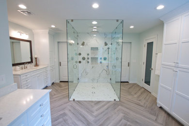 Bathroom - large contemporary master white tile and porcelain tile porcelain tile, brown floor, double-sink and wainscoting bathroom idea in Other with shaker cabinets, white cabinets, a two-piece toilet, white walls, an undermount sink, quartz countertops, a hinged shower door, white countertops and a built-in vanity