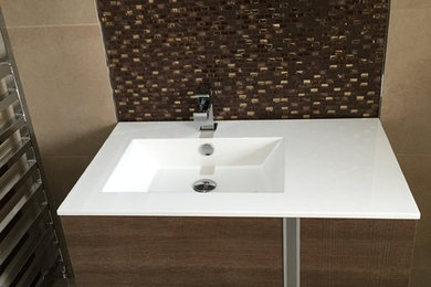 Inspiration for a small contemporary ensuite bathroom in Hampshire with flat-panel cabinets, medium wood cabinets, a double shower, beige tiles, porcelain tiles, porcelain flooring and a wall-mounted sink.