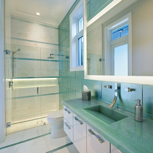 Inspiration for a large contemporary 3/4 bathroom in Miami with flat-panel cabinets, white cabinets, an alcove shower, a one-piece toilet, green tile, glass tile, green walls, marble floors, an integrated sink, glass benchtops and turquoise benchtops.