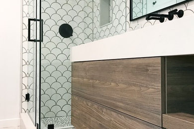 This is an example of a large contemporary ensuite bathroom in Los Angeles with flat-panel cabinets, dark wood cabinets, an alcove shower, white tiles, ceramic tiles, white walls, light hardwood flooring, an integrated sink, solid surface worktops, beige floors, a hinged door and white worktops.