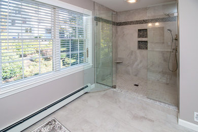 Alcove shower - mid-sized contemporary master white tile and porcelain tile porcelain tile and white floor alcove shower idea in Manchester with raised-panel cabinets, white cabinets, a two-piece toilet, gray walls, an undermount sink, quartz countertops, a hinged shower door and multicolored countertops