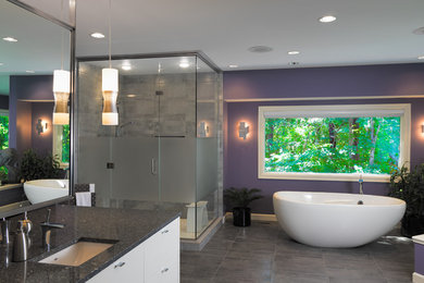 Mid-sized eclectic master gray tile and porcelain tile porcelain tile and gray floor bathroom photo in Other with flat-panel cabinets, white cabinets, purple walls, an undermount sink, granite countertops and a hinged shower door