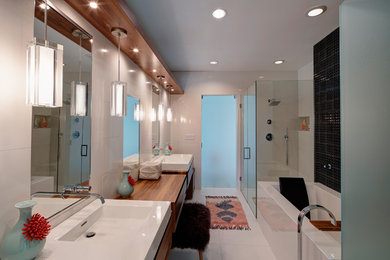 Bathroom - mid-sized contemporary master white tile, black tile and porcelain tile porcelain tile and white floor bathroom idea in Chicago with medium tone wood cabinets, a wall-mount toilet, white walls, a hinged shower door, flat-panel cabinets, an integrated sink and solid surface countertops