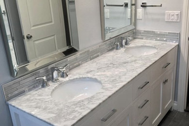 Inspiration for a medium sized contemporary ensuite bathroom in Los Angeles with shaker cabinets, white cabinets, grey tiles, glass tiles, grey walls, a submerged sink, marble worktops and grey floors.
