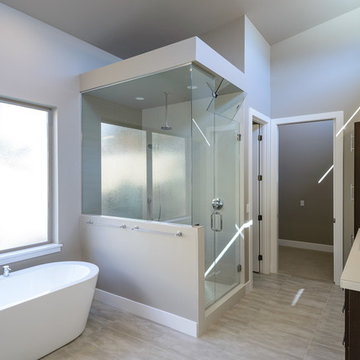 Contemporary master bathroom with walk-in closet