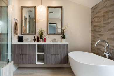 Mid-sized trendy master beige tile and porcelain tile porcelain tile and beige floor alcove shower photo in San Francisco with flat-panel cabinets, dark wood cabinets, beige walls, an undermount sink, solid surface countertops and a hinged shower door