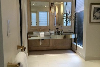 Example of a large minimalist master white tile and porcelain tile porcelain tile, white floor, single-sink and wall paneling bathroom design in Houston with a vessel sink, white walls, glass-front cabinets, a two-piece toilet, glass countertops, a hinged shower door and a freestanding vanity