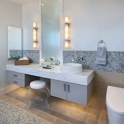 Example of a trendy multicolored tile and mosaic tile mosaic tile floor bathroom design in San Francisco with flat-panel cabinets, gray cabinets, a one-piece toilet, gray walls and a vessel sink