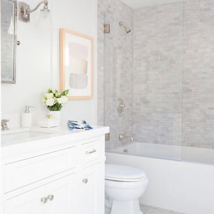 Elegant gray tile bathroom photo in Los Angeles with furniture-like cabinets, white cabinets, white walls and an undermount sink