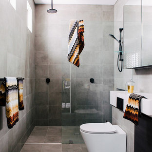 Photo of a contemporary shower room bathroom in Sydney with an alcove shower, a one-piece toilet, grey walls, grey tiles, cement tiles, a wall-mounted sink, grey floors and an open shower.