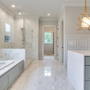 Inspiration for a huge transitional master gray tile and marble tile white floor and marble floor bathroom remodel in Nashville with shaker cabinets, white walls, a hinged shower door, blue cabinets, marble countertops and white countertops