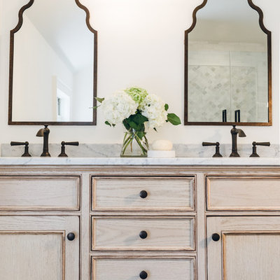 Bathroom - mid-sized traditional master white tile and stone tile bathroom idea in New York with beaded inset cabinets, distressed cabinets, a one-piece toilet, white walls, an undermount sink and marble countertops