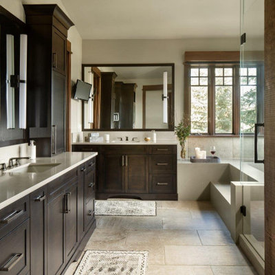 Large mountain style master beige tile beige floor and single-sink bathroom photo in Denver with dark wood cabinets, white countertops, shaker cabinets, beige walls, an undermount sink and a built-in vanity