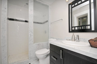 Doorless shower - contemporary 3/4 subway tile marble floor doorless shower idea in Vancouver with black cabinets, a one-piece toilet, beige walls and marble countertops