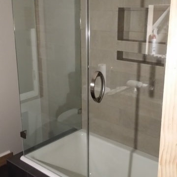 Corner Tub Frameless Glass Enclosure (ShowerGuard) with Portals Hardware.