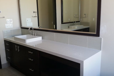 Bathroom - mid-sized modern master white tile and glass sheet bathroom idea in Orange County with flat-panel cabinets, dark wood cabinets and quartzite countertops