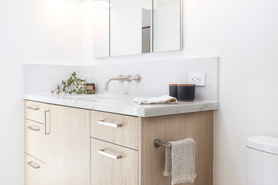 Example of a mid-sized danish 3/4 mosaic tile floor and white floor bathroom design in San Francisco with flat-panel cabinets, light wood cabinets, white walls, an undermount sink, quartzite countertops and gray countertops