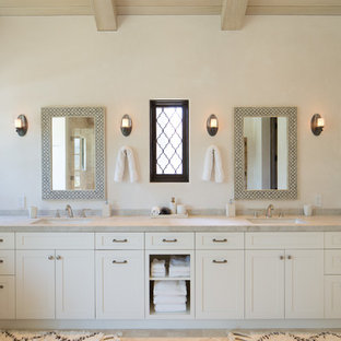 Inspiration for a mediterranean master bathroom in Los Angeles with quartzite benchtops, shaker cabinets, beige cabinets, beige walls, an undermount sink, beige benchtops, limestone floors and beige floor.
