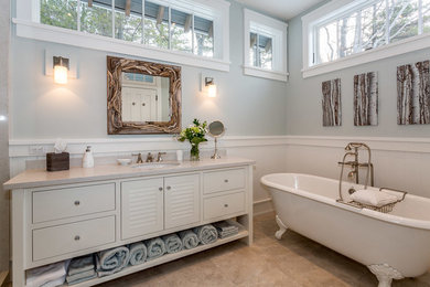 Beach style master beige floor claw-foot bathtub photo in Toronto with furniture-like cabinets, white cabinets, gray walls and an undermount sink