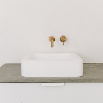 Counter top basin and wall hung brass tap