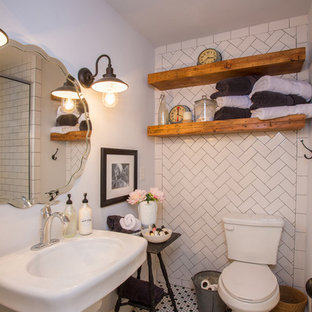 Bathroom - small country white tile multicolored floor bathroom idea in Austin with a two-piece toilet, white walls and a pedestal sink
