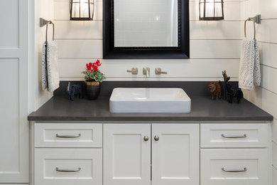 Mid-sized transitional 3/4 white tile dark wood floor and multicolored floor bathroom photo in Minneapolis with shaker cabinets, white cabinets, white walls, a drop-in sink and solid surface countertops