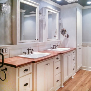 Mid-sized farmhouse master bathroom photo in Dallas with shaker cabinets, white cabinets, blue walls and wood countertops