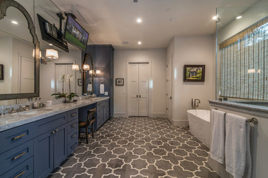 Large minimalist master multicolored tile cement tile floor and gray floor bathroom photo with shaker cabinets, blue cabinets, a one-piece toilet, multicolored walls, an undermount sink, granite countertops, a hinged shower door and gray countertops