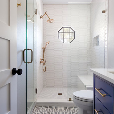 Inspiration for a small transitional 3/4 white tile and porcelain tile multicolored floor and cement tile floor alcove shower remodel in Austin with flat-panel cabinets, blue cabinets, an undermount sink, a hinged shower door, white countertops and solid surface countertops