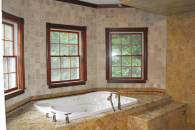 Mid-sized elegant master ceramic tile bathroom photo in Bridgeport with a hot tub and beige walls