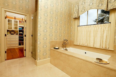 ニューオリンズにあるトラディショナルスタイルのおしゃれなマスターバスルーム (大理石の洗面台、アンダーマウント型浴槽、バリアフリー、ベージュのタイル、石タイル、ベージュの壁、大理石の床) の写真