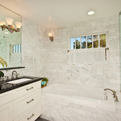 Example of a trendy white tile and marble tile bathroom design in San Diego with white cabinets