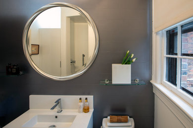 Bathroom - small modern 3/4 white tile and porcelain tile ceramic tile, gray floor, single-sink, tray ceiling and wainscoting bathroom idea in Baltimore with flat-panel cabinets, white cabinets, a two-piece toilet, gray walls, a wall-mount sink, solid surface countertops, white countertops and a floating vanity