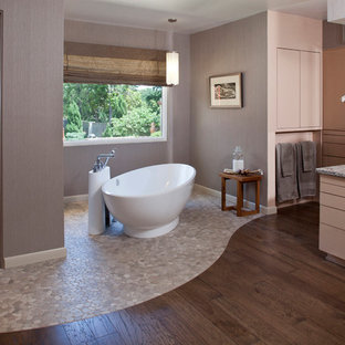 Inspiration for a contemporary bathroom in Other with a freestanding tub and pebble tile floors.