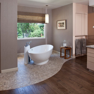 Freestanding bathtub - contemporary pebble tile floor freestanding bathtub idea in Other