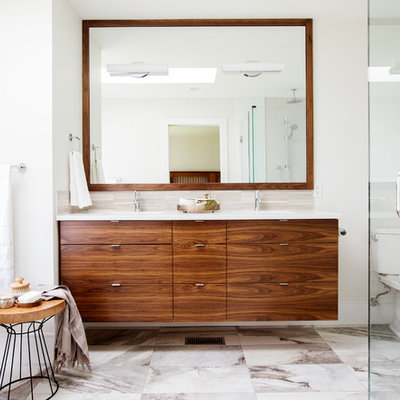 Example of a trendy master beige tile and porcelain tile porcelain tile and multicolored floor bathroom design in Vancouver with flat-panel cabinets, a two-piece toilet, white walls, an undermount sink, quartz countertops, a hinged shower door and medium tone wood cabinets