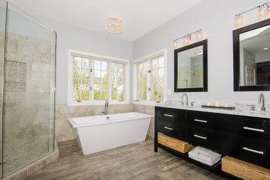 Inspiration for a medium sized classic ensuite bathroom in DC Metro with a submerged sink, shaker cabinets, dark wood cabinets, granite worktops, a freestanding bath, a corner shower, a two-piece toilet, beige tiles, ceramic tiles, blue walls, porcelain flooring, brown floors and a hinged door.