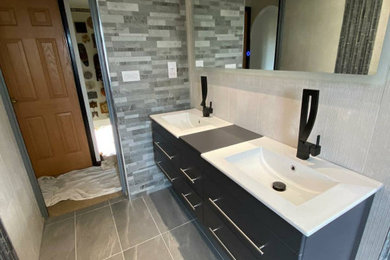 Photo of a medium sized contemporary family bathroom in Other with grey cabinets, grey tiles, porcelain tiles, double sinks and a floating vanity unit.