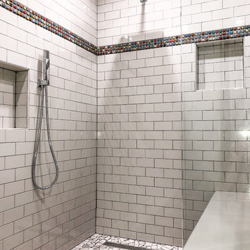 Curbless Shower with Decorative Stone Pan, Bench Seat & Glass Wall