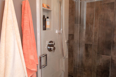 Ispirazione per una piccola stanza da bagno con doccia stile americano con doccia a filo pavimento, piastrelle di ciottoli, pareti marroni e lavabo rettangolare