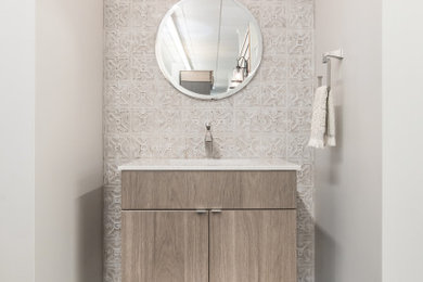 Inspiration for a small transitional 3/4 beige tile and ceramic tile multicolored floor bathroom remodel in Other with flat-panel cabinets, medium tone wood cabinets, marble countertops, white countertops, beige walls and an integrated sink
