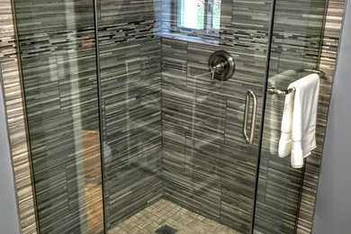 Inspiration for a mid-sized rustic master gray tile and porcelain tile porcelain tile corner shower remodel in Chicago with gray walls and a hinged shower door