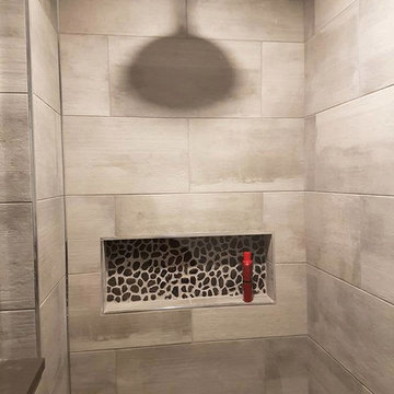 Custom bathroom with stone pebble base and niche