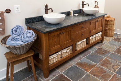 Bathroom - mid-sized rustic master blue tile and stone slab slate floor and multicolored floor bathroom idea in DC Metro with shaker cabinets, medium tone wood cabinets, a two-piece toilet, beige walls, a vessel sink and soapstone countertops