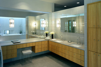 Example of a trendy master bathroom design in Dallas with flat-panel cabinets, light wood cabinets and limestone countertops