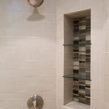 Custom glass tiles accent areas of bath