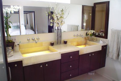 Example of a mid-sized minimalist master travertine floor and beige floor bathroom design in Los Angeles with flat-panel cabinets, brown cabinets, white walls and a trough sink