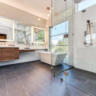 Trendy master white tile gray floor bathroom photo in Other with flat-panel cabinets, dark wood cabinets, white walls and a hinged shower door