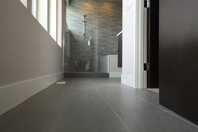 Example of a small trendy master beige tile and ceramic tile porcelain tile and gray floor alcove shower design in Seattle with flat-panel cabinets, dark wood cabinets, an undermount tub, gray walls, a vessel sink, quartzite countertops and a hinged shower door